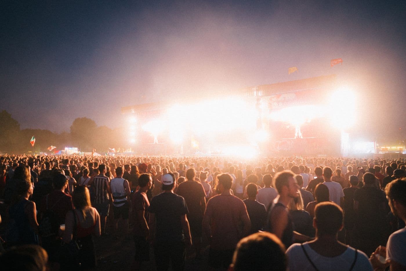 A warm golden-dusk festival crowd at sunset