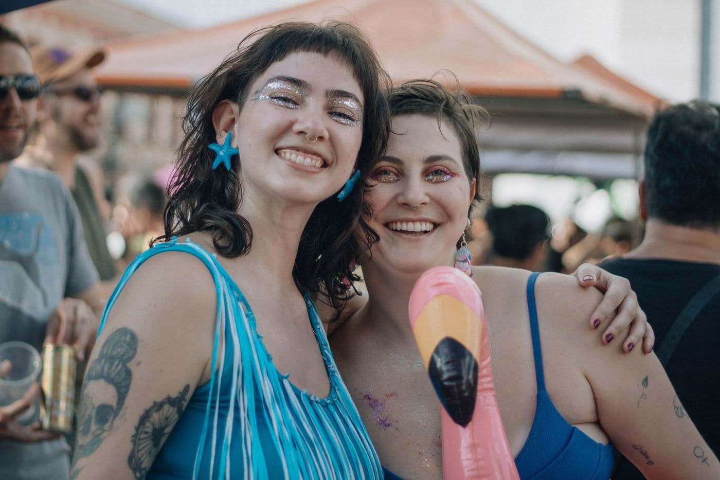 Two friends covered in glitter, laughing together