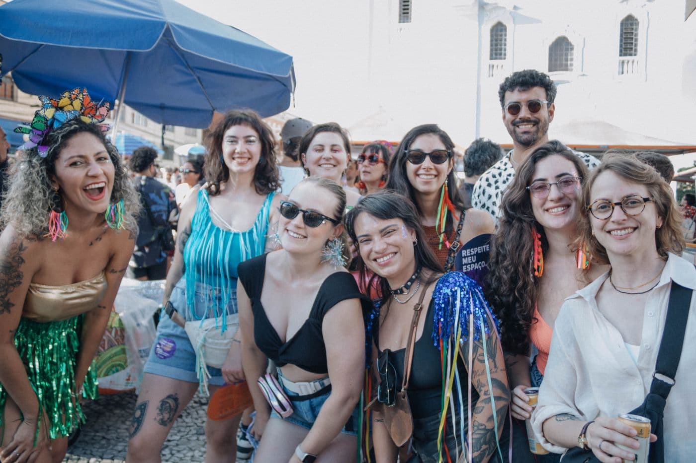 A whole crew grinning together at a festival